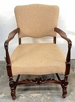 Front view of mahogany upholstered armchair