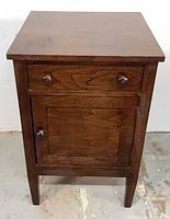 Front view closed showing drawer and door