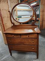 Front view showing serpentine front dresser, drawer configuration, round mirror