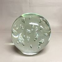 Front view of clear glass sphere displaying internal bubbles