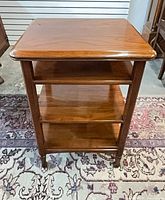 Front view showing three tiers and turned legs