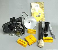 All items in lot: camera, flash equipment, filters, film boxes, manual