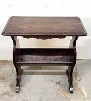 Front view of solid wood side table with magazine rack shelf