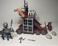 Medieval siege tower, knights, horse, weapons, boulders visible