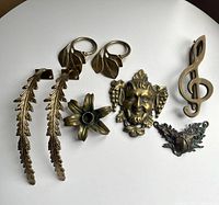 All seven brass items arranged on table