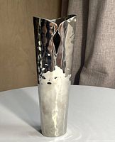 Full view of vase front showing hammered finish and V-shaped opening