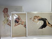 Three Esquire Vargas pin-up prints in protective sleeves, showing fronts