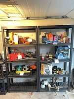 Front view of both black resin shelving units with five shelves each