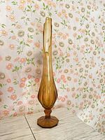 Full view of amber swung vase on table