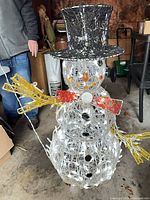 Front view snowman with lights on showing hat, bow tie, arms