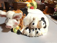 Left side view of ceramic pig cookie jar with piglets and corn-handled lid