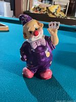 Full view of porcelain clown piggy bank standing on table