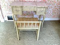 Vanity with matching upholstered chair positioned underneath