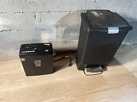 garbage can and shredder side by side