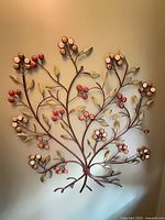 Metal wall art with berry and leaf design