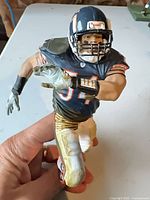 Front view of Brian Urlacher action figure showing jersey and pose