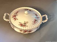 Covered bowl with lid showing floral pattern and gold trim