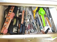 Full drawer showing utensils, flatware and knives