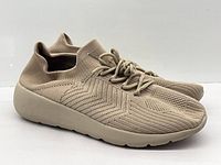 Side view of both sneakers showing knit texture and soles