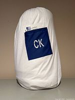 Comforter in storage bag with CK embroidery