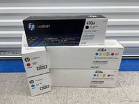 Front view of five sealed HP 410A toner cartridge boxes