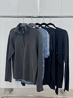 All four tops hanging on rack