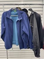 Four jackets grouped on hangers showing colors and styles