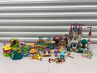 Wide shot showing castle, multiple playsets, camper van, figures spread out
