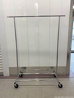 Full front view of chrome rolling clothing rack