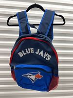 Full front view of Toronto Blue Jays kids backpack showing team name and logo, red zipper, mesh pockets