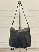 Full front view of bag showing rectangular shape and logo patch