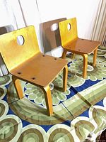 Front view of both bent plywood children’s chairs