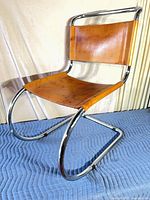 Front three-quarter view showing chrome frame and leather panels