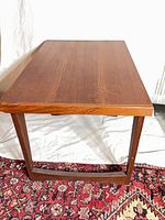 Top and side view of teak veneer end table on rug