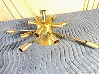 Overhead view of metallic Sputnik ceiling fixture showing eight arms and central cylinder