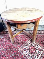 Full view of round oak poker table on rug