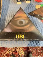 Top of triangular box showing UBI eye graphic