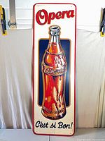 Full front view of Opera soda tin sign