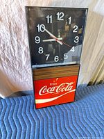 Full view of vintage Coca-Cola clock light showing clock face and illuminated logo panel