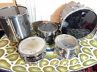 Full view of five chrome drums on table