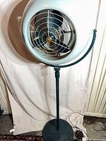 Full view of vintage Vornado pedestal fan on round base