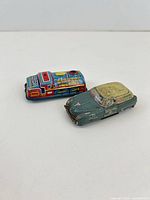 Both tin cars side by side showing overall form and colour