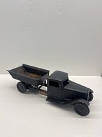 Full view of black pressed steel dump truck