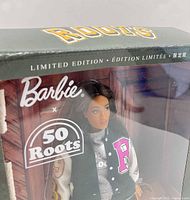 Close-up of box front showing Barbie x 50 Roots logo and Limited Edition text