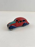 Left front perspective of red/teal litho tin car
