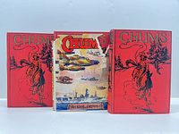 Front view of three Chums Annual volumes showing red covers and one dust-jacketed volume