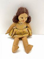 Front view of Norah Wellings cloth doll seated