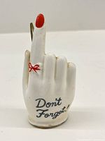 Front view showing hand shape, text, and red accents