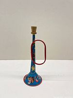 Front view of blue litho tin horn with red handle and graphics