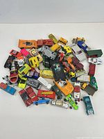 Pile of approximately 40 assorted die-cast toy cars and trucks